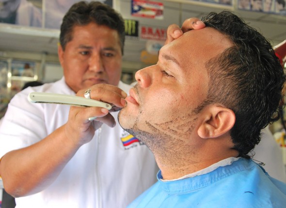 Aurelio Bohórquez da forma a la barba y patillas de Pedro Morán en la Peluquería Mi Alborada.